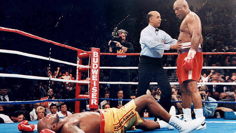 George Foreman standing over Michael Moorer at his comeback match for the world heavyweight title on November 5th 1994
